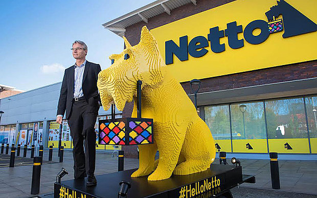 Chief executive of Netto's parent company, Dansk Supermarked, with Bright Bricks' dog made from Lego Photo: Paul Cooper
